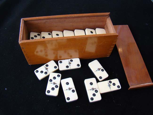 A late 19th century boxed set of bone and ebony dominoes